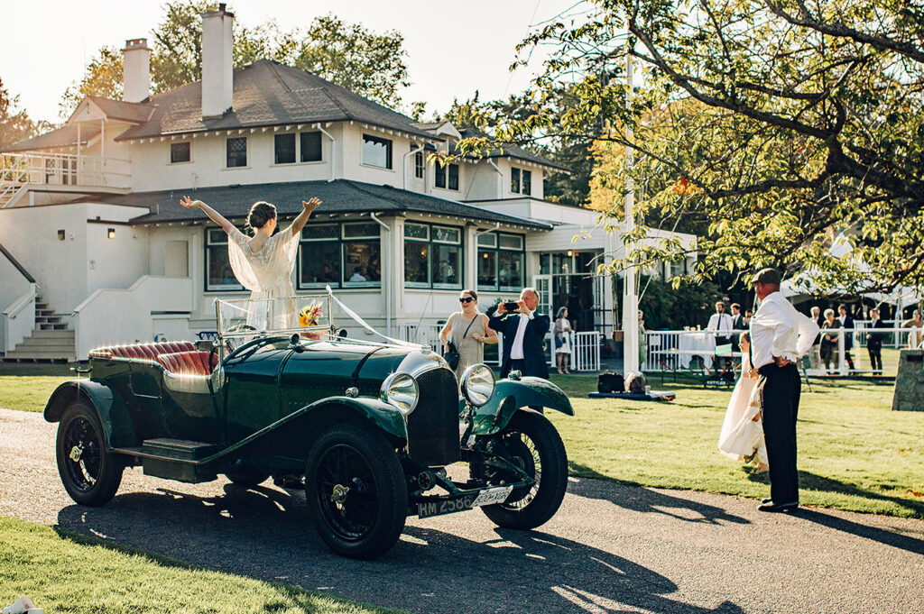 bride in a vintage car at the royal Victoria yacht club