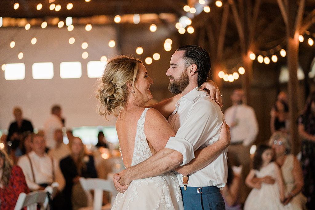 bride and groom first dance at a wedding reception in a barn-like building at highlands pacific golf course